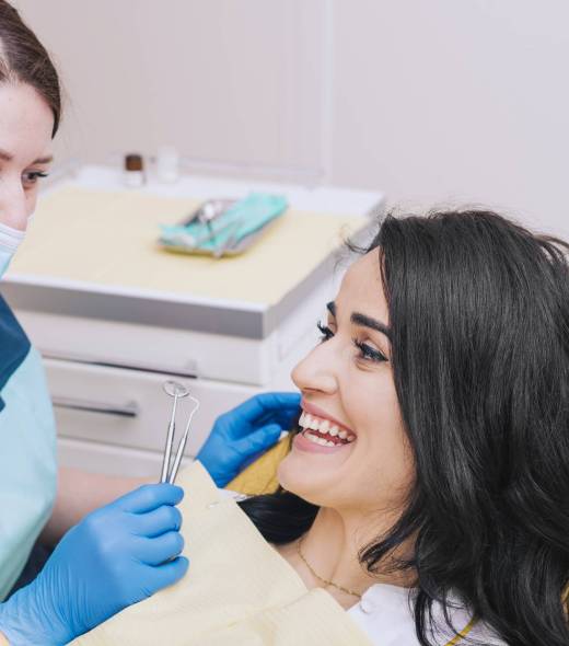 dentist-sitting-near-female-patient